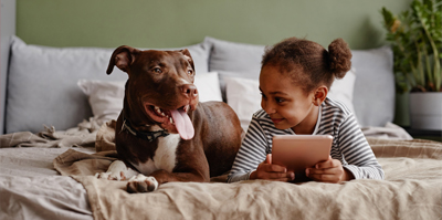 Girl and dog on bed