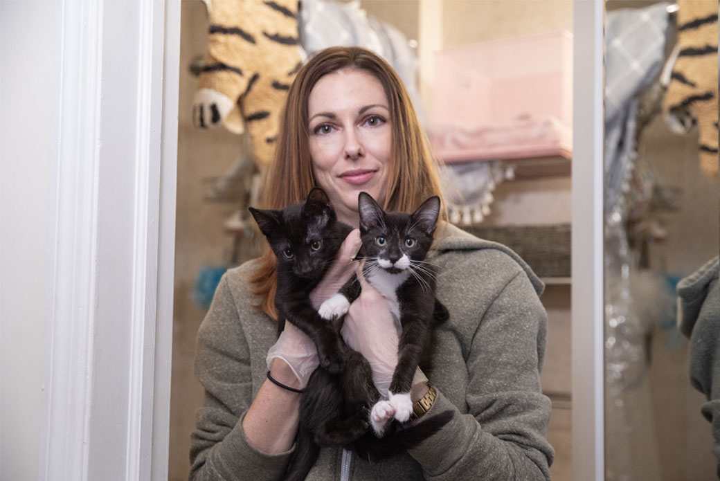 Woman holding two kittens